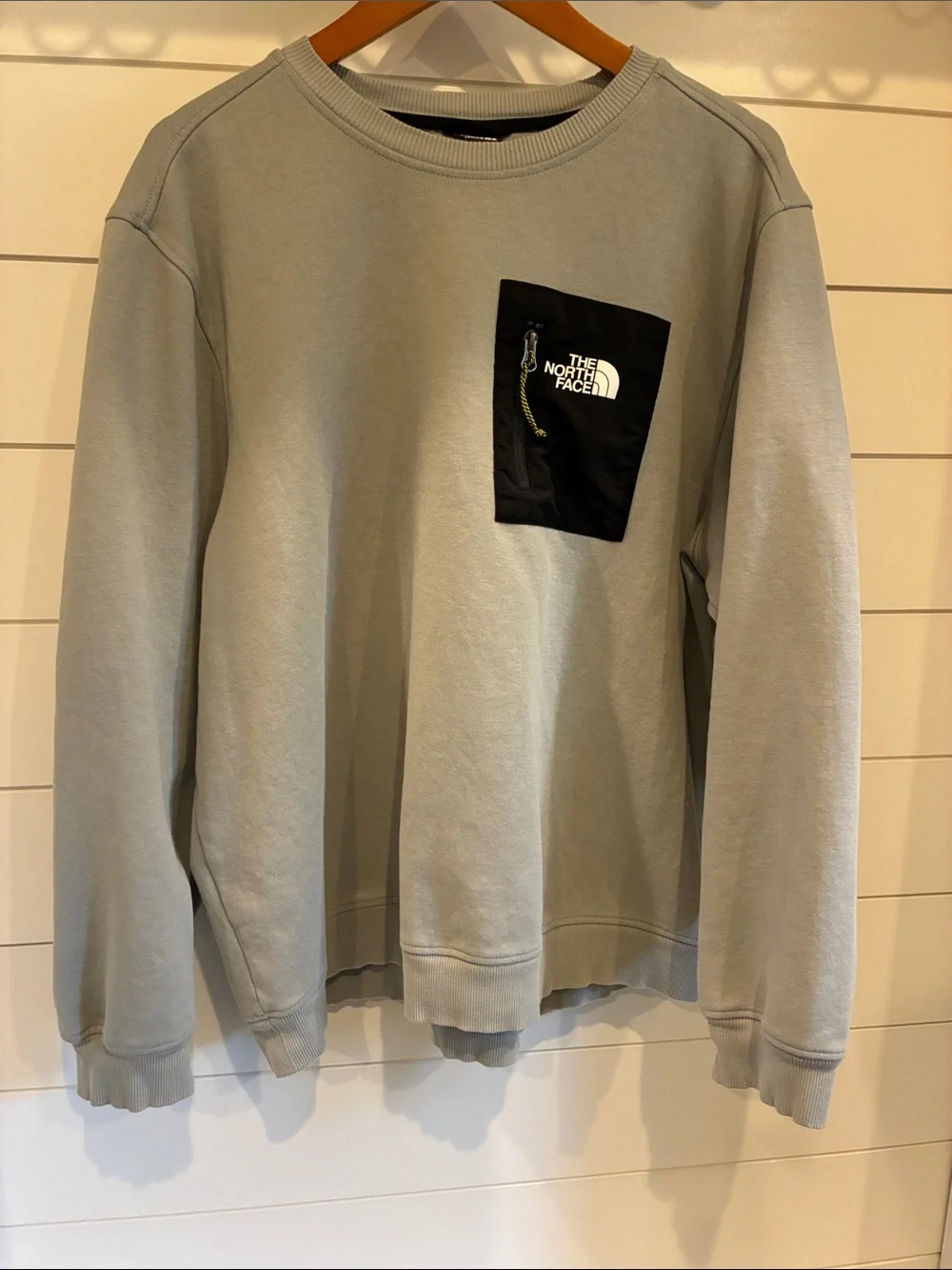 The North Face Men's Light Gray Crewneck Sweatshirt with Black Chest Pocket